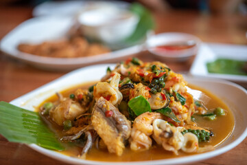 Fried stir spicy seafood on the table.
