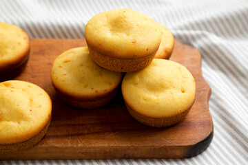 Homemade Cornbread Muffins on a rustic wooden board, low angle view. Close-up.