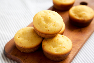 Homemade Cornbread Muffins on a rustic wooden board, side view. Close-up.