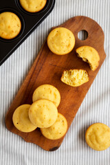 Homemade Cornbread Muffins on a rustic wooden board, view from above. Flat lay, overhead, top view.