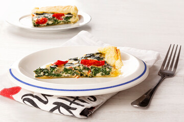 Home made spinach quiche on plate.