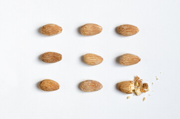 symmetrically lying almonds on a white background