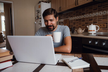 Portrait of happy man having a cup of coffee in kitchen