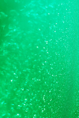 Green glitter bokeh circle glow blurred and blur abstract. Glittering shimmer bright luxury . White and silver glisten twinkle for texture wallpaper and background backdrop.
