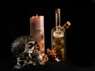 composition of objects, skull, candle and bottle