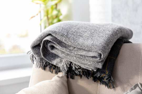 Neatly Folded Blankets On The Sofa