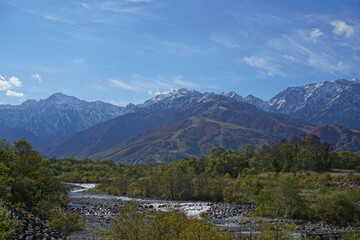 Fototapeta premium Autumn colorful foliage. mountains have 3 different colors made by nature, white, red, green. 