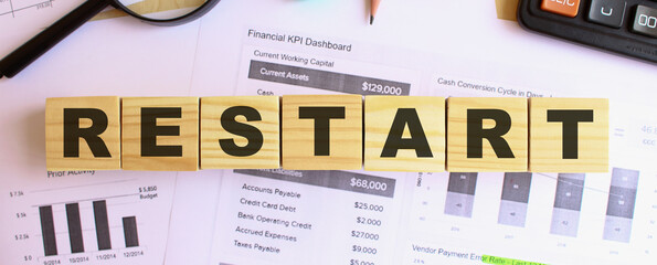 RESTART the word on wooden cubes. Background is a business diagram. Business and finance concept