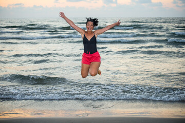 Fototapeta na wymiar Jumping woman at sea