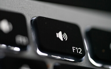 Close up of Keyboard volume mute key on space grey metal. High quality photo