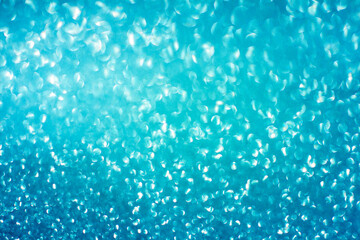Blue glitter bokeh circle glow blurred and blur abstract. Glittering shimmer bright luxury . White and silver glisten twinkle for texture wallpaper and background backdrop.
