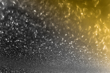 Black glitter bokeh circle glow blurred and blur abstract. Glittering shimmer bright luxury . White and silver glisten twinkle for texture wallpaper and background backdrop.
