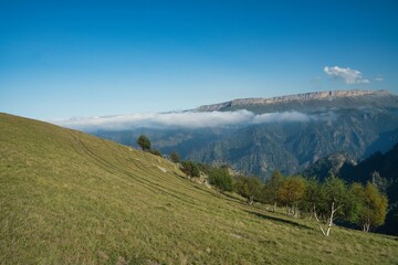 Fototapeta premium soaring clouds against the backdrop of the mountain