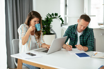 Husband and wife preparing bills to pay. Young couple having financial problems...