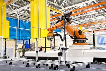 ULYANOVSK, RUSSIA - SEPTEMBER 6, 2016: Huge orange robot machine in a modern colorful assembly hall (shop) in Russia.