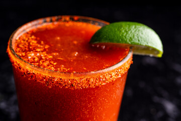 A delicious red cocktail, margarita, bloody mary with tahini and lime. © strotter13
