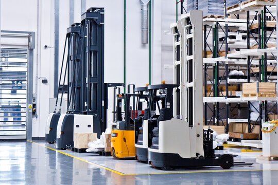 New self propelled lifting platforms in a white warehouse of a factory.