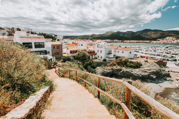 Fototapeta na wymiar Road leading to traditional mediterranean town with white houses and beach