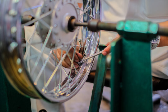 Close-up of spokes and wheels alignment of motorcycle repair.