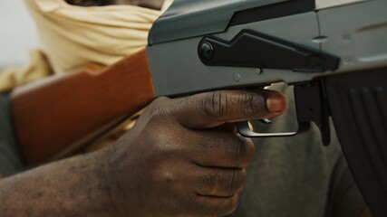Concept of terrorism. Rebel soldier aiming at targets with an AK-47 machine gun. Close up. High quality photo