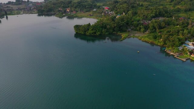 Aerial view of blue Lake Toba and Samosir Island in North Sumatra, Indonesia - tilt up pan left