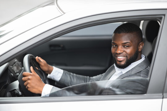 Side View Of Black Man Driver Looking Through Car Window