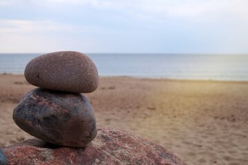 Fototapeta na wymiar Two stacked natural rocks on a sandy beach