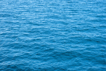 Surface of beautiful deep blue ocean background texture for background or backdrop..