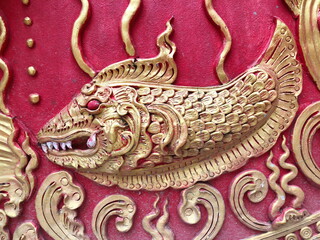 Traditional Thai style stucco on the wall of church in temple, Thailand.