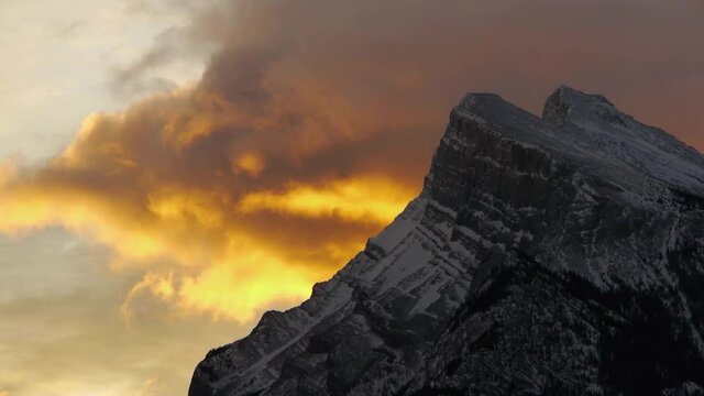 Mount Rundle at sunset in Banff National Park from Vermillion Lakes in winter. Zoomed in on clouds.