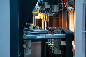 The preform shape of PET bottle in the blowing mold machine. The operation of PET bottle processing by blowing process with the blowing mold.