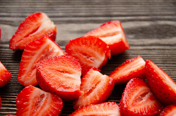 red raw fresh strawberries on wooden background, close view 