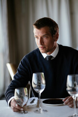 Handsome businessman drinking wine. Businessman enjoying in the restaurant