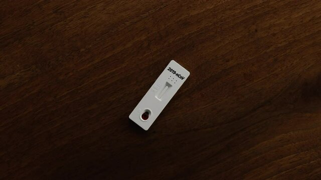 Rapid Covid-19 Strip Test on the wood table