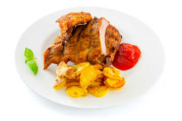 Roasted sliced barbecue pork ribs, fried potatoes served with ketchup in a white plate isolated on the white background. A portion of fresh, delicious smoked pork ribs with fried potatoes.