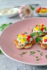 Canape or crostini with toasted bread, light cheese and colorful bell pepper. Top view with copy space.