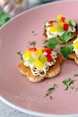 Canape or crostini with toasted bread, light cheese and colorful bell pepper. Top view with copy space.