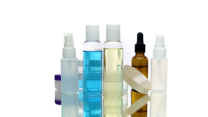 Set natural cosmetic daily skincare cleansing products rotating, different bottles, jars with liquids in action isolated on white background. Skin care routine trends, dermatology, beauty, treatment