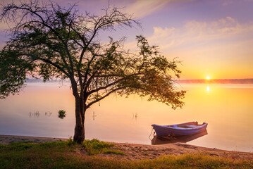 Boat on the lake in the rays of the rising sun and fog, zemborzycki lake © RafalDlugosz
