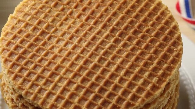Heap of fresh baked traditional Dutch syrup waffle close up