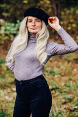 Close up portrait of pretty blonde woman wearing trendy casual outfit