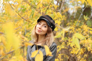 Beautiful woman and yellow leaves in the park in autumn