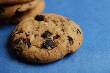 cookies festive round with chocolate drops close up on a blue background there is a copy space for the text of the photo