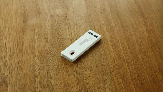 Rapid Covid-19 Strip Test on the wood table