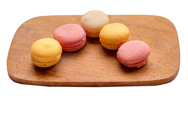Assorted individual macaroons on a wooden plate