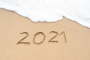 Hello 2021 signs on the sandy beach. Welcoming 2021 with new resolutions, dreams concept.