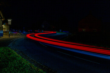 traffic at night through Avebury in Wiltshire.