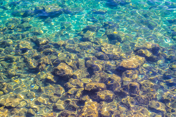 Fototapeta na wymiar rocks and reflections in the blue sea
