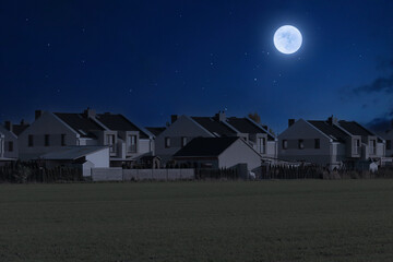 Modern housing estate on a moonlit night