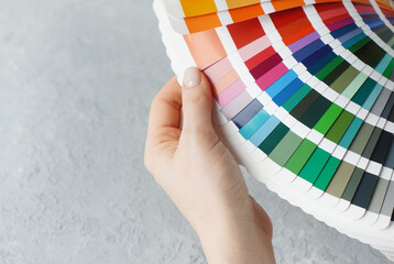 Colour catalogue for interior design in female hands